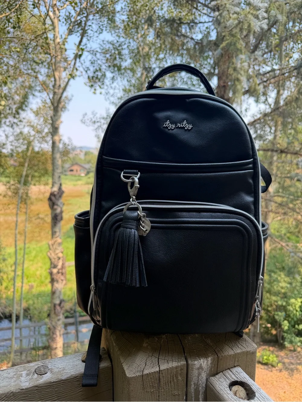 Itzy Ritzy Black Faux Leather Baby Backpack with Tassel Charm